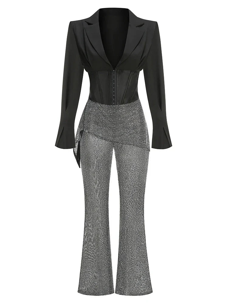 Black blazer and gray patterned pants on a white background
