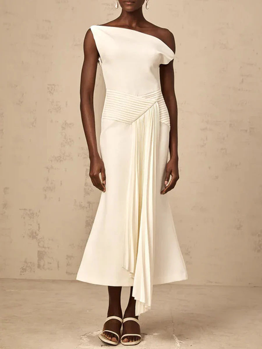 Woman wearing a white one-shoulder dress against a beige background