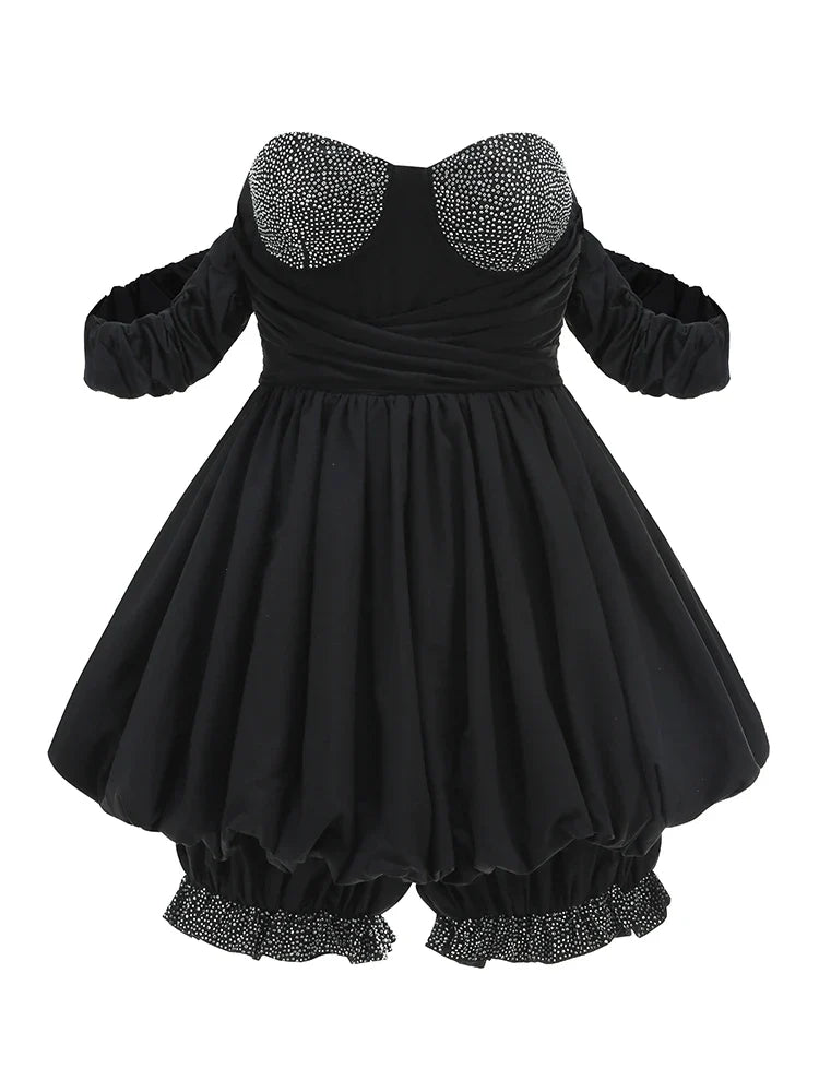 Black dress with embellished collar and hem on a white background