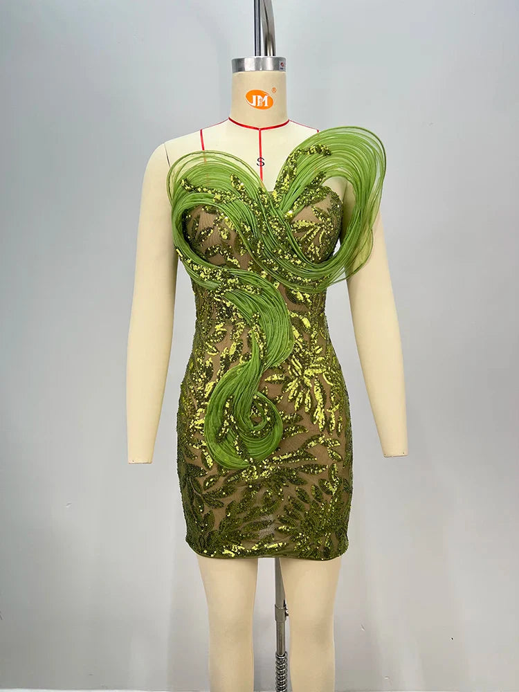 Green sequin dress on a mannequin against a gray background