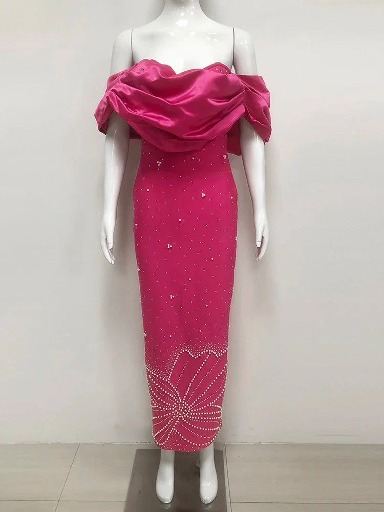 Mannequin wearing a pink evening gown with a draped top on a white background