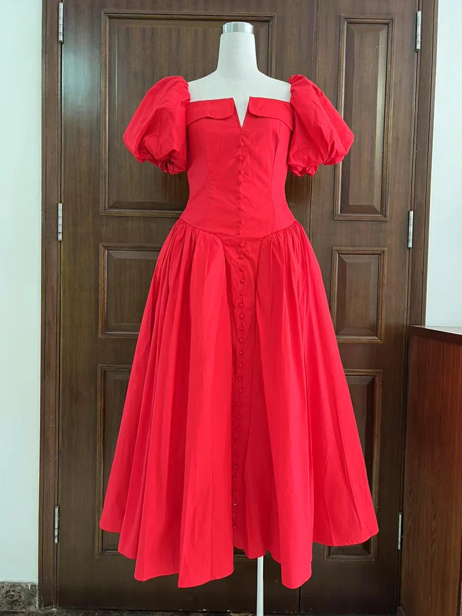 Red dress on a mannequin against a wooden door background
