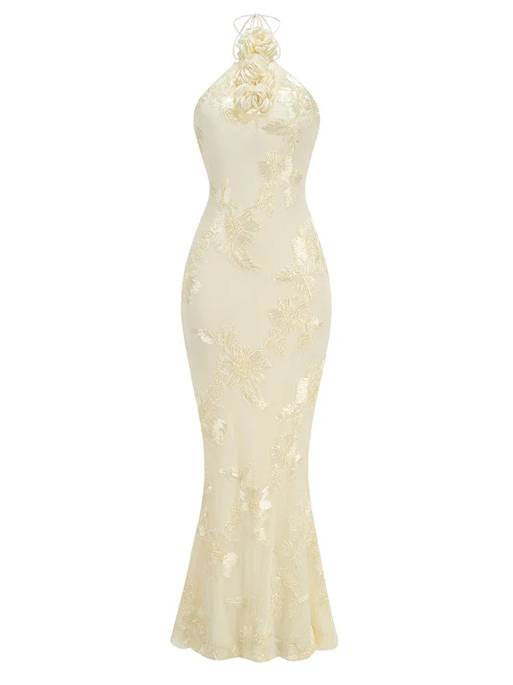 Elegant white evening gown with floral details on a white background
