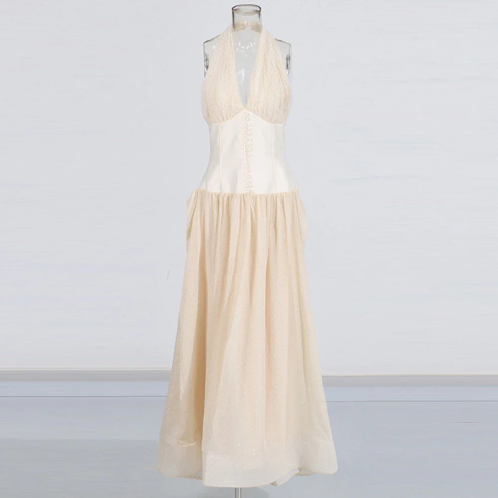 Beige dress on a mannequin against a plain background