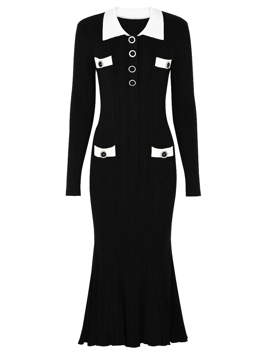Black dress with white collar and buttons on a white background