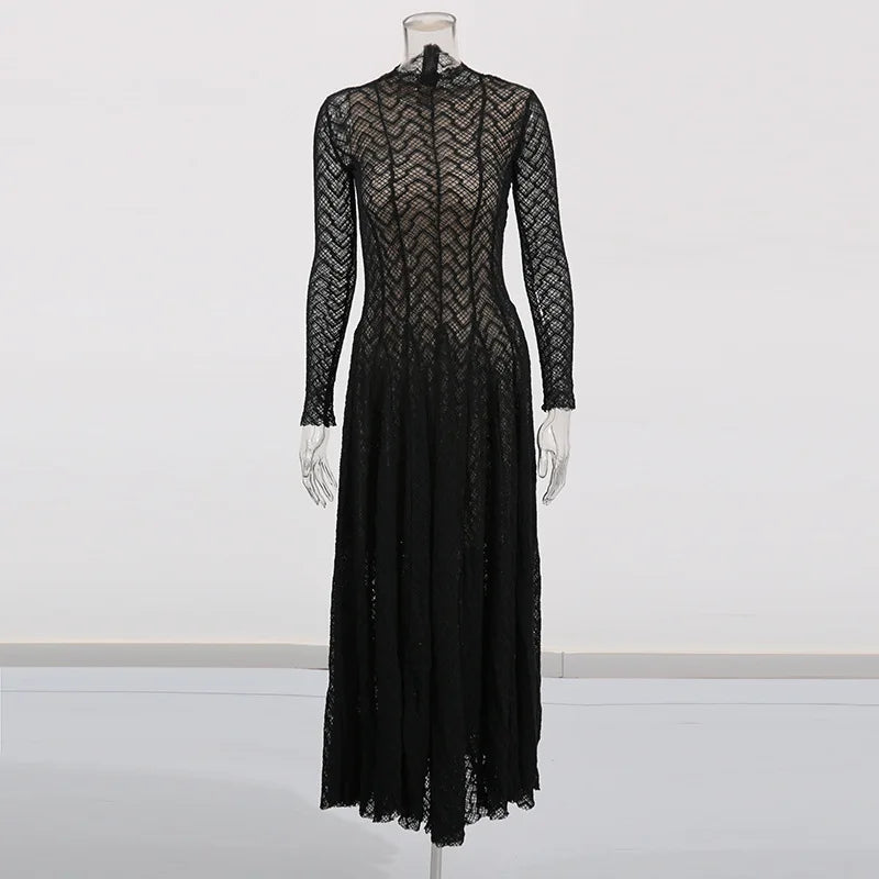Black lace dress on a mannequin against a white background