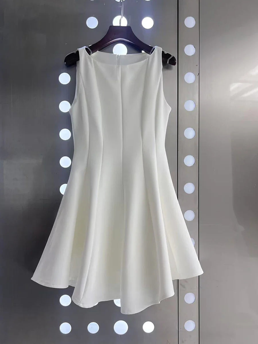 White sleeveless dress on a hanger against a polka dot background