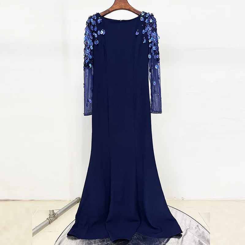 Navy blue dress with blue sequin embellishments on a white background
