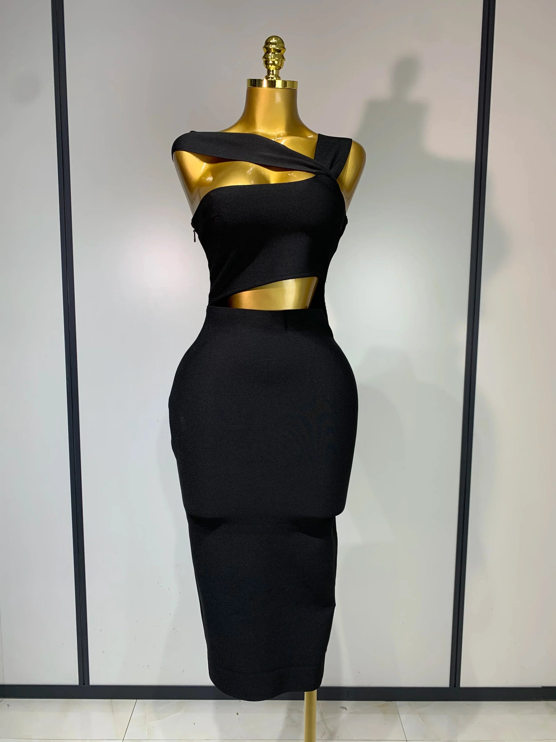 Black dress on a mannequin against a white background