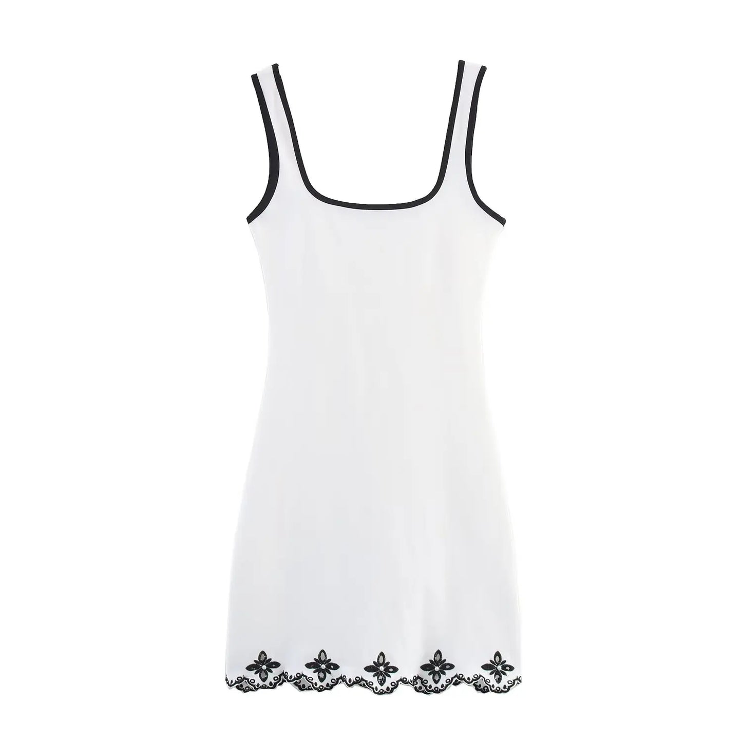 White slip dress with black lace trim on a white background