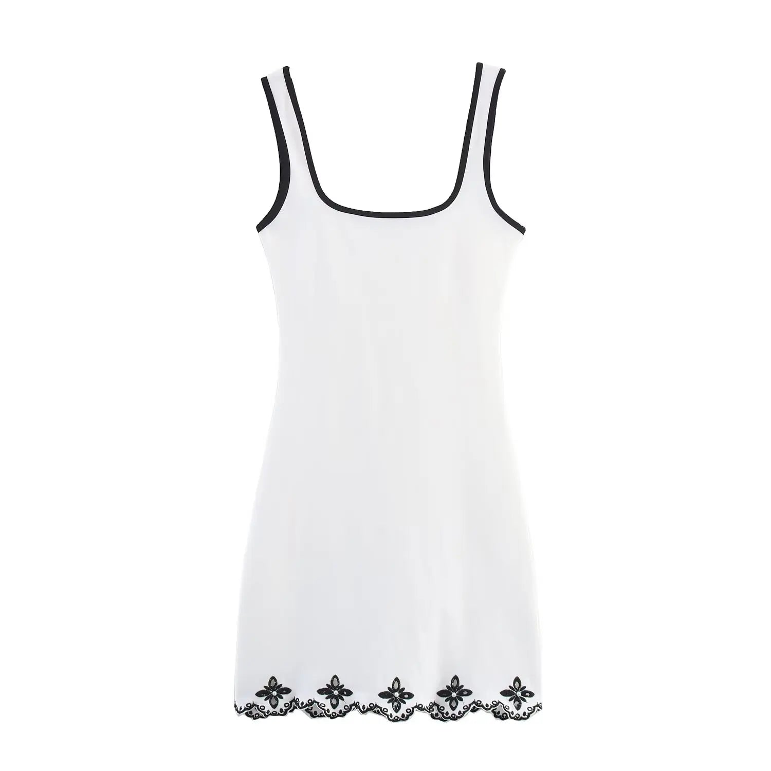White slip dress with black lace trim on a white background