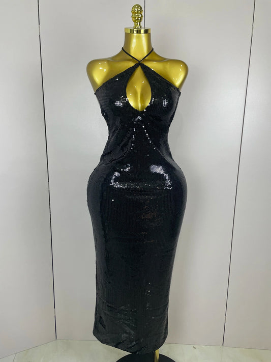 Black sequin dress on a mannequin against a white background