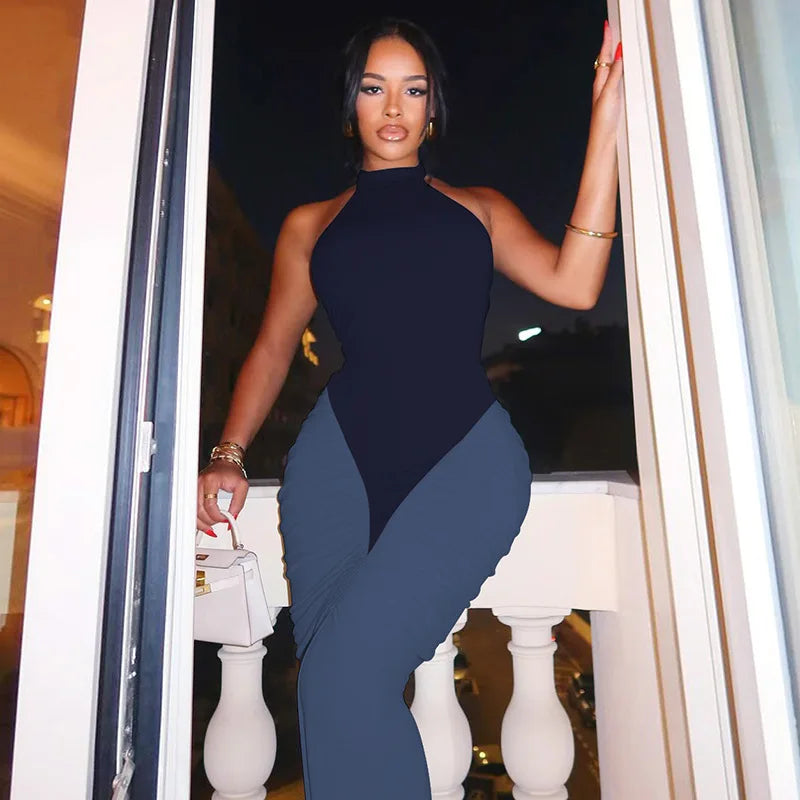 Woman in a blue dress standing in a doorway with a blurred background