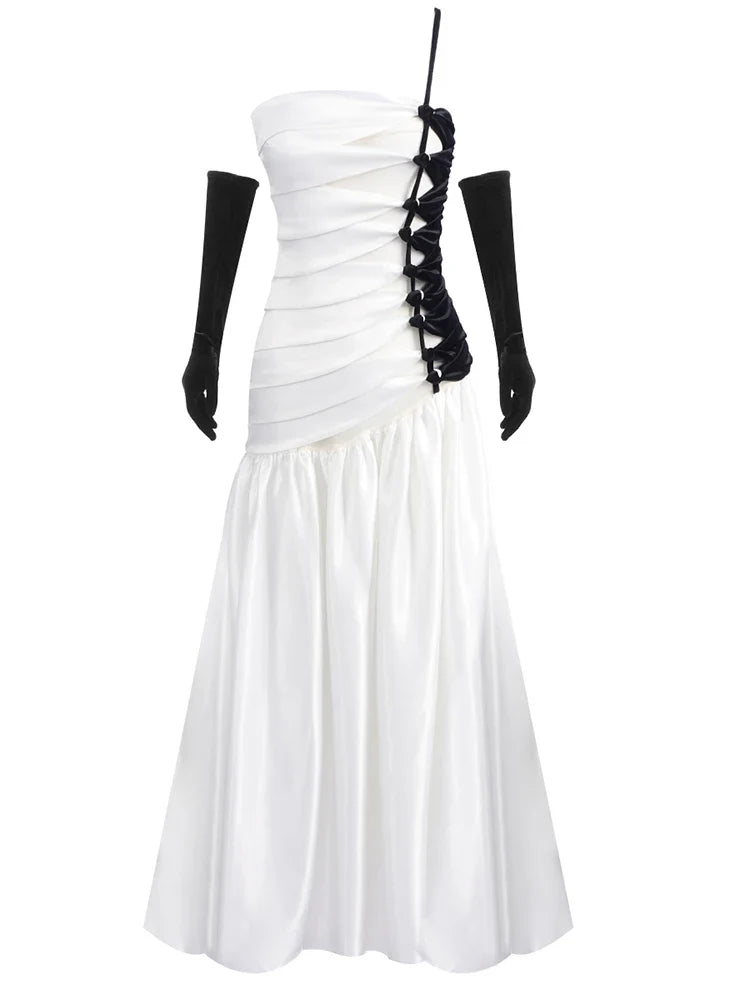 White strapless dress with black lace detailing on a white background