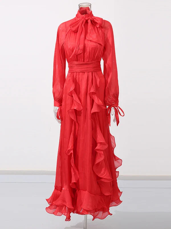 Red evening gown with ruffled layers on a white background