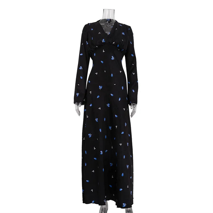 Black dress with blue floral pattern on a mannequin against a white background