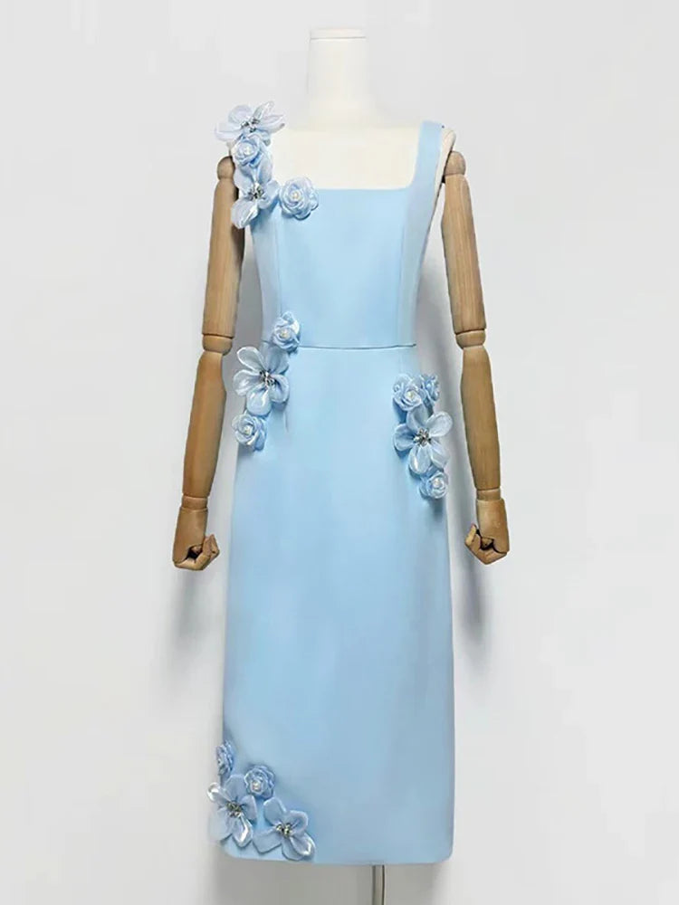 Light blue dress with floral embellishments on a mannequin against a white background