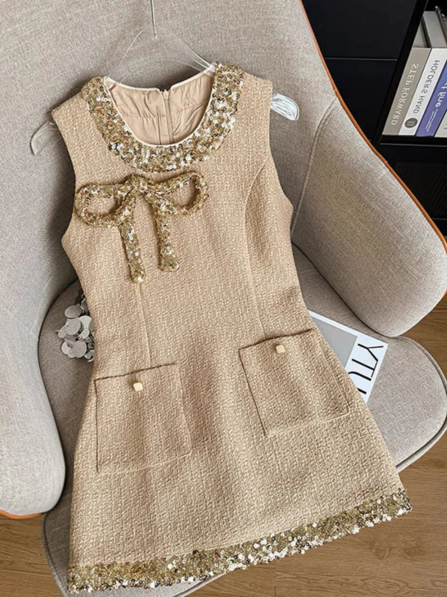 Beige dress with sequin details on a chair