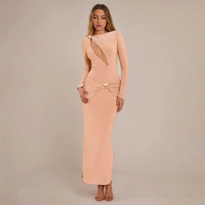 Woman wearing a peach evening gown with cut-out design on a beige background