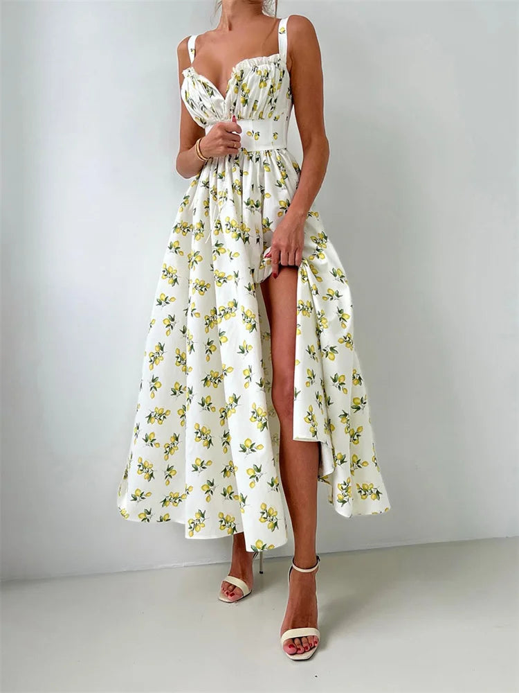 Woman wearing a floral dress with a slit on a plain background