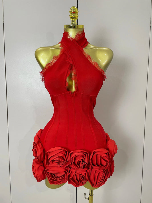Red dress with floral details on a mannequin against a white background