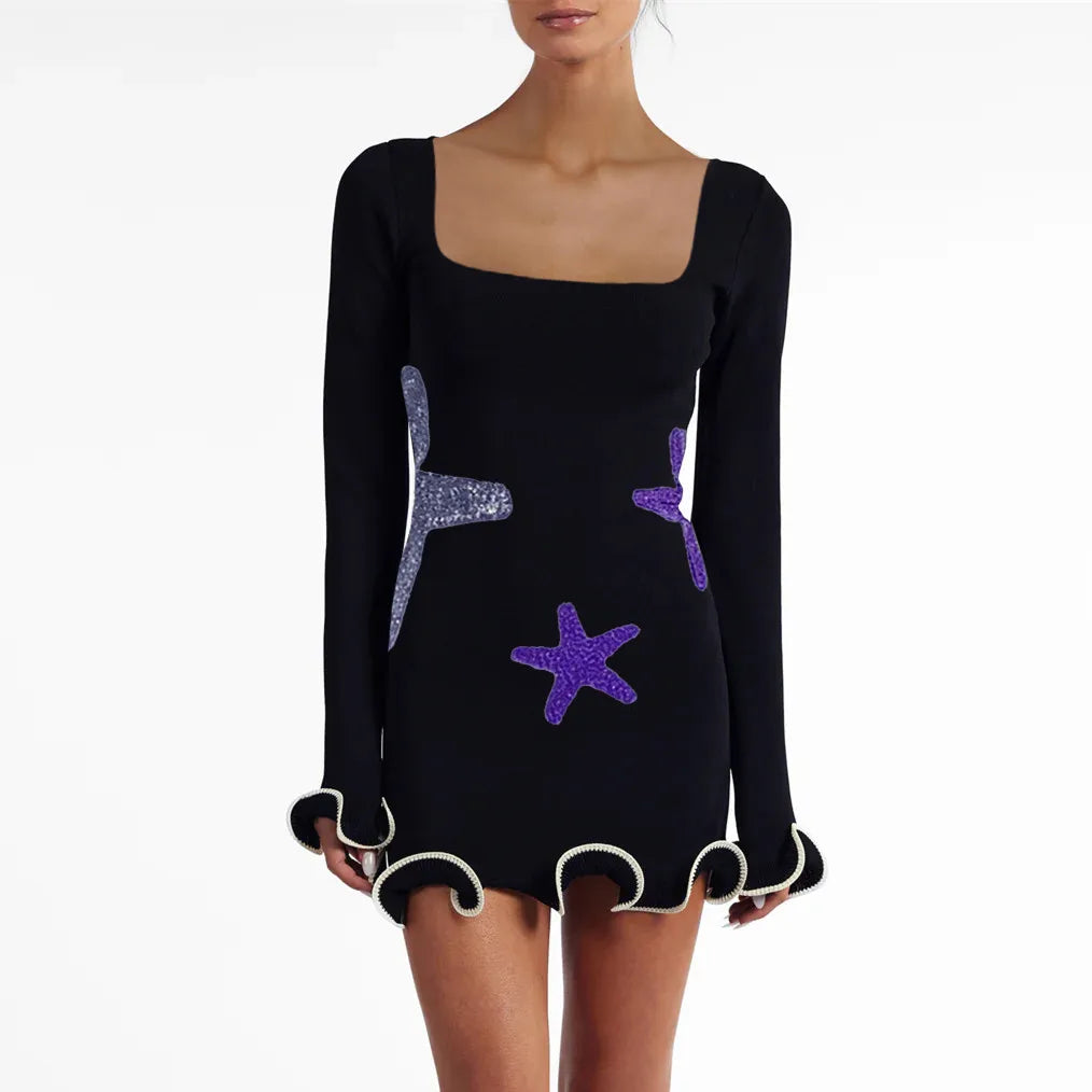 Black dress with starfish patterns on a white background