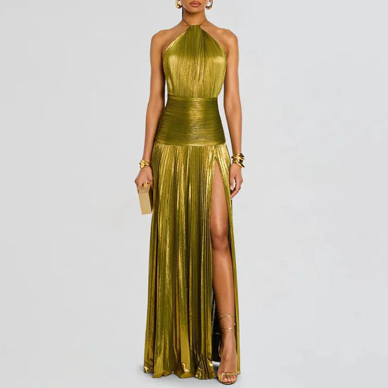 Woman wearing a gold  green halter neck gown with a slit on a light gray background