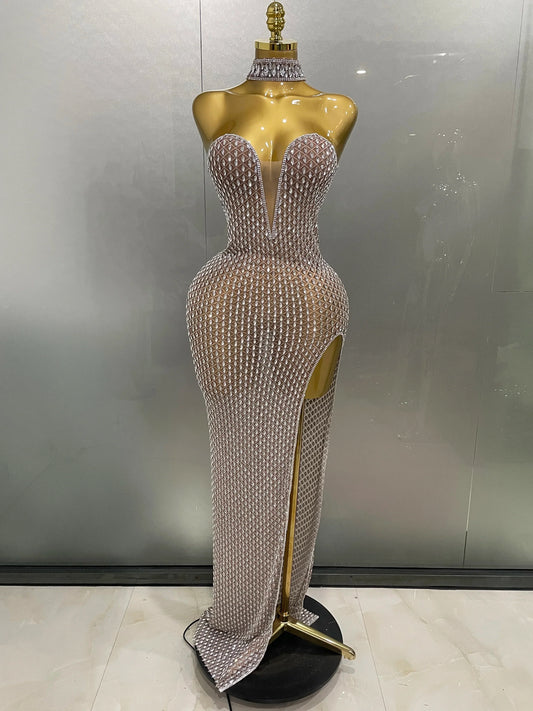 Silver beaded evening gown on a mannequin against a plain background