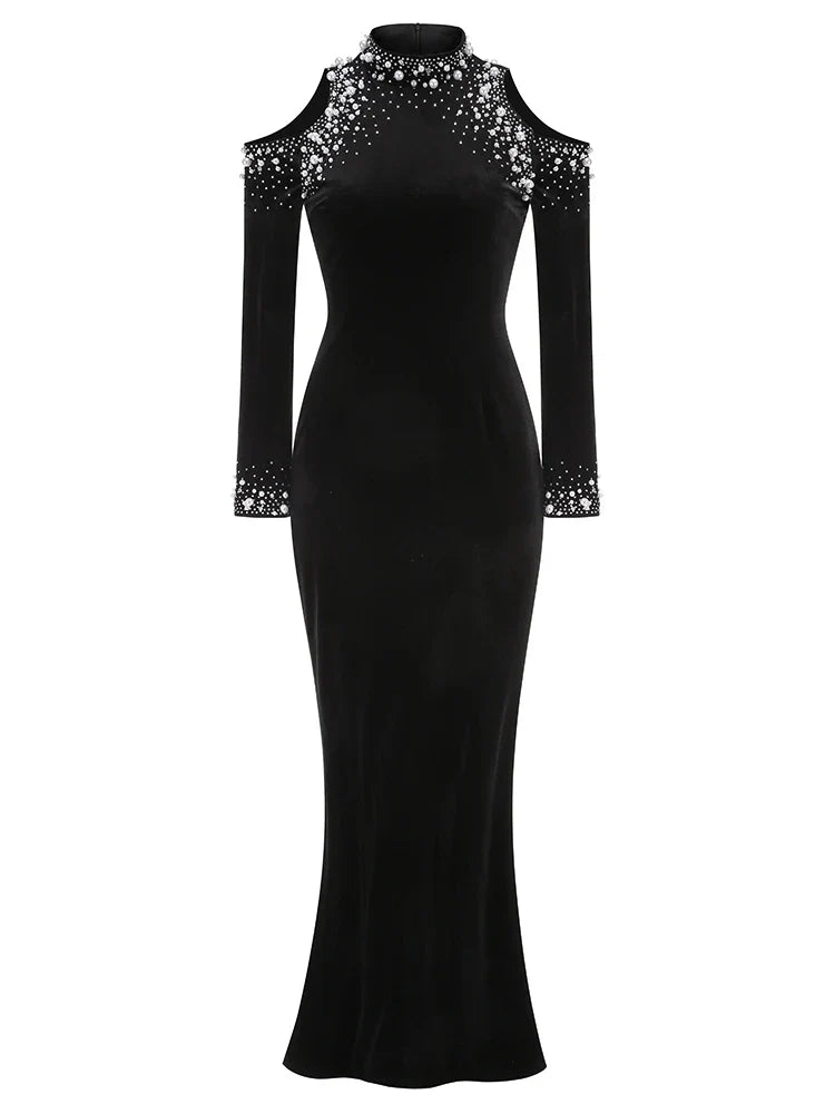 Black evening gown with sheer sleeves and embellishments on a white background