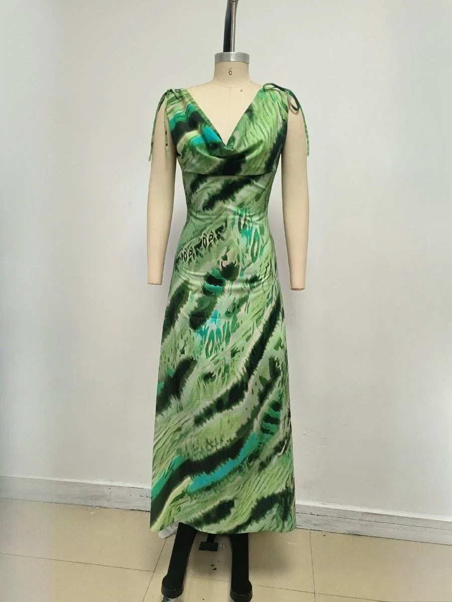 Green patterned dress on a mannequin against a white background