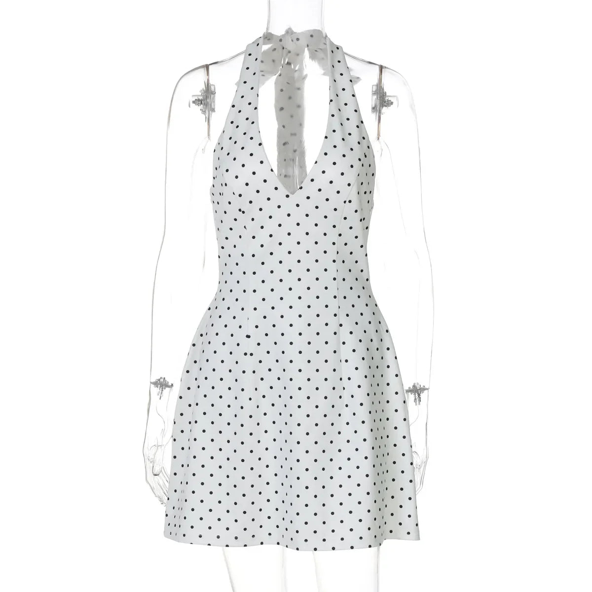 White dress with black polka dots on a mannequin against a white background