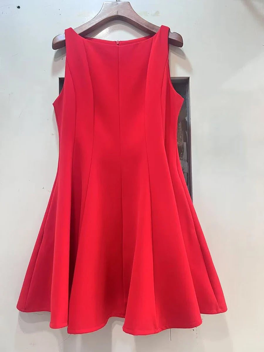 Red dress on a hanger against a white wall
