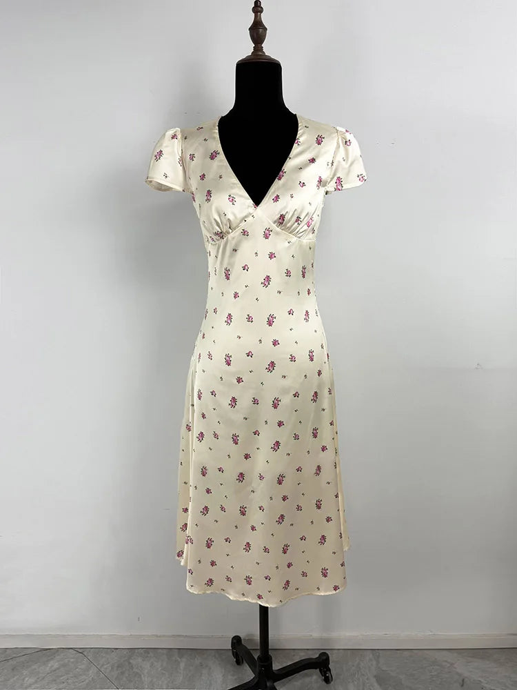 Floral dress on a mannequin against a plain background