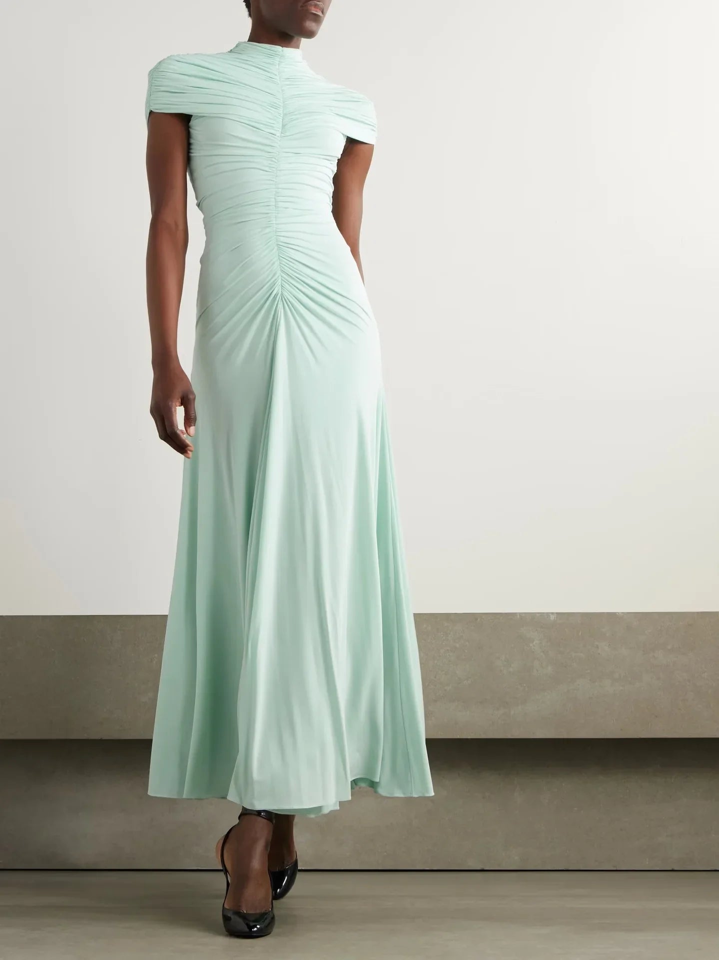 Mint green evening gown on a neutral background