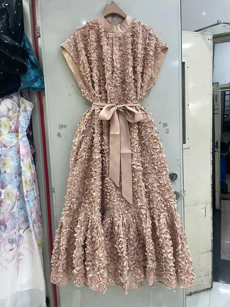 Beige floral dress with a belt hanging on a mirror