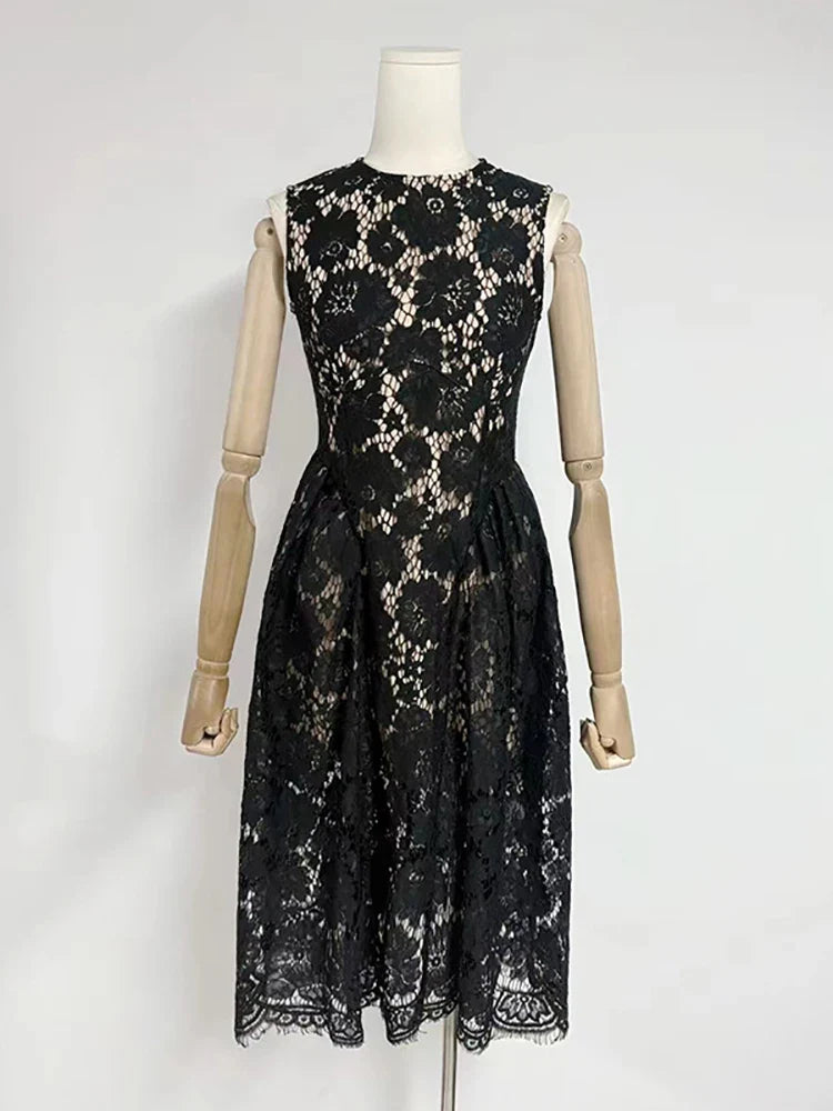 Black lace dress on a mannequin against a white background