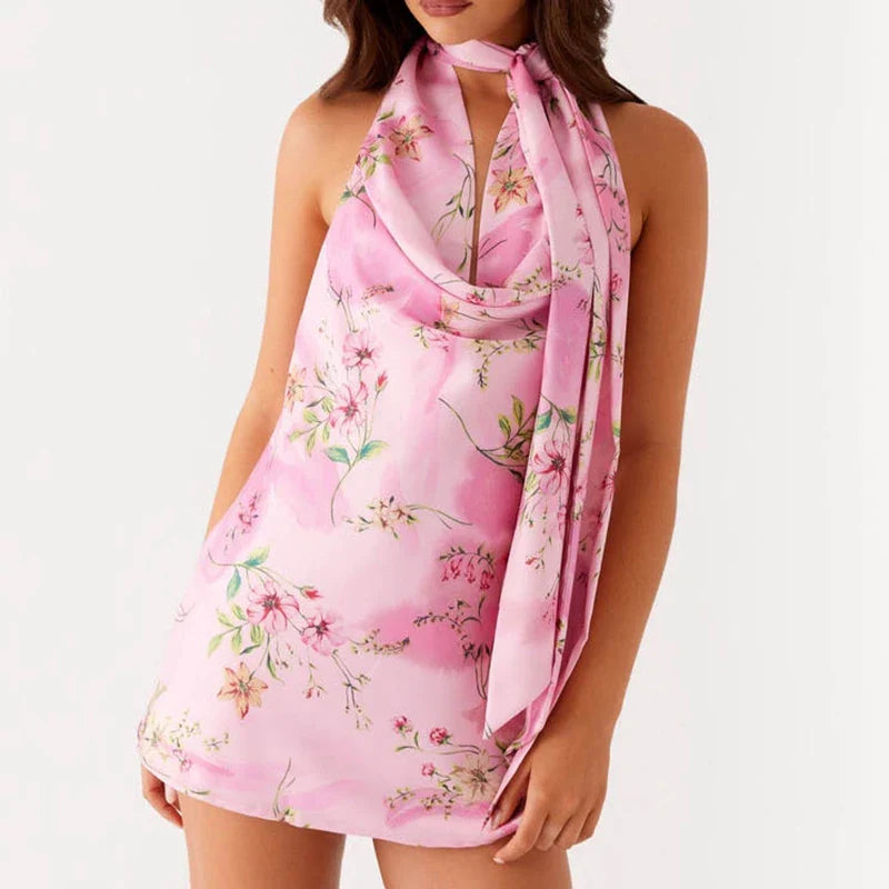 Woman wearing pink floral halter mini dress with scarf tie