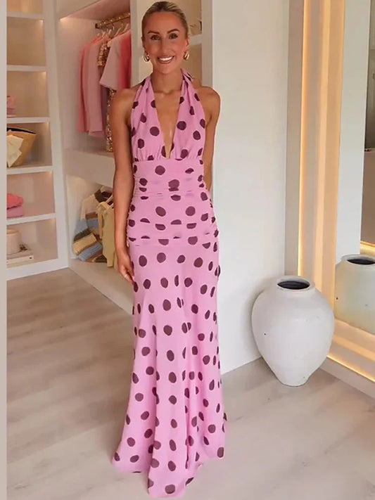 Front view of pink polka dot halter dress styled for summer events