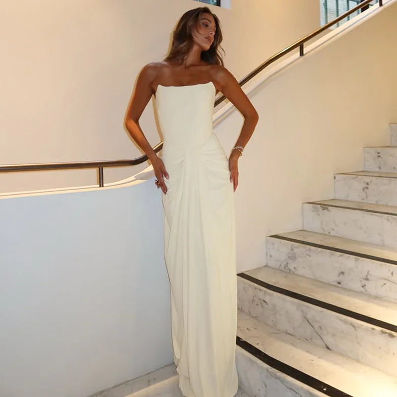 A full-length view of the backless, elegant evening party dress.
